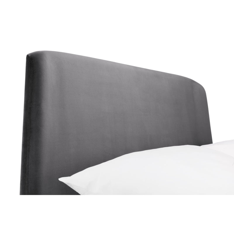 Gray upholstered headboard with a white pillow on a white background