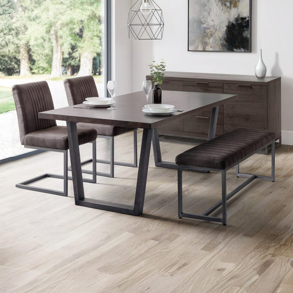Dining room set with table, chairs, and bench on a wooden floor.