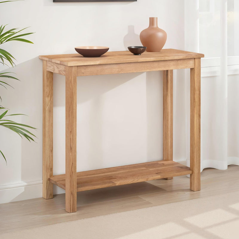 Wooden console table with decorative items against a white wall.