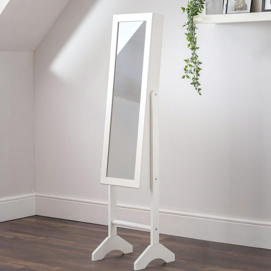 White standing mirror against a white wall with a plant decoration.