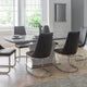 Modern dining room with a glass dining table and black chairs.
