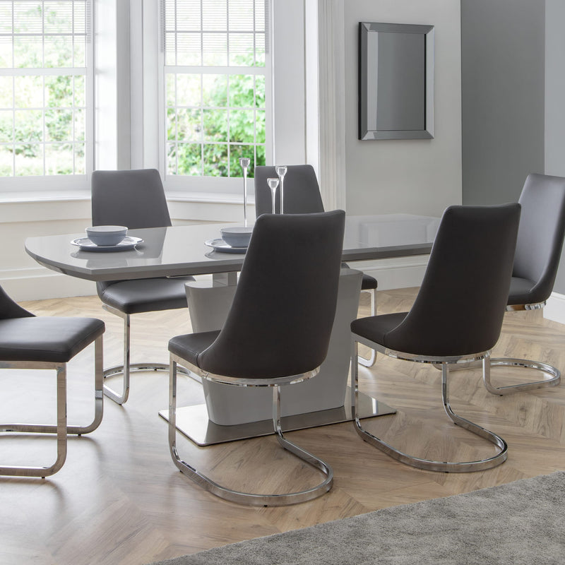 Modern dining room with a glass dining table and black chairs.
