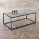 Coffee table with a concrete top and black metal frame on a wooden floor.