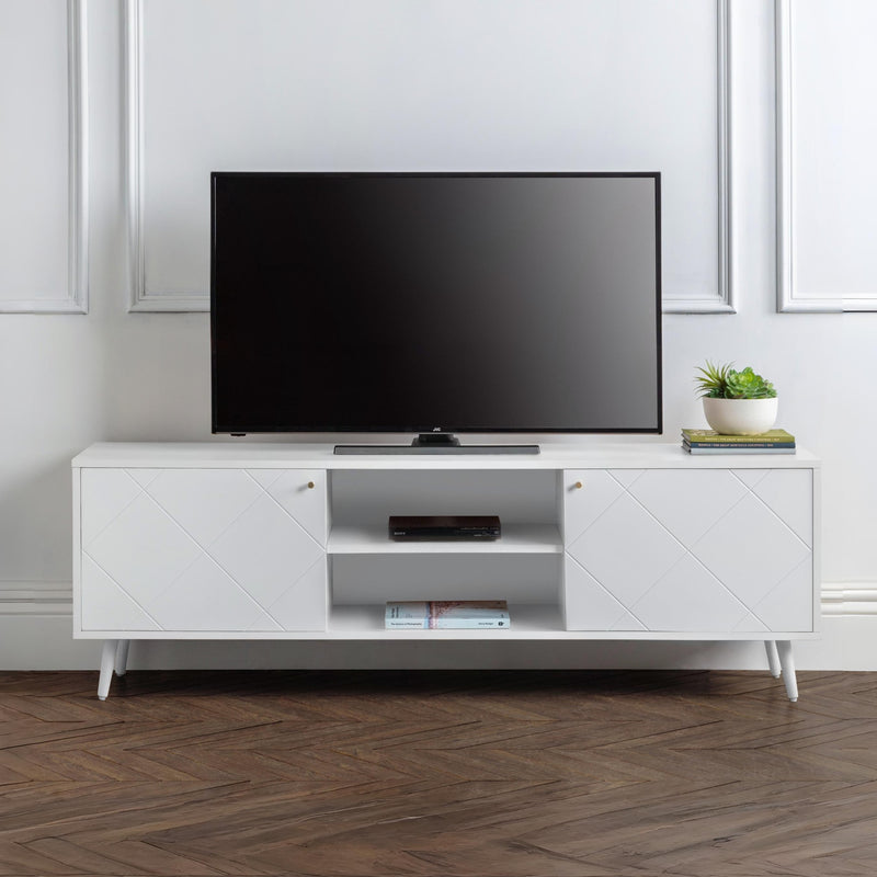 White TV stand with a black TV on top in a room with wooden flooring and white walls.