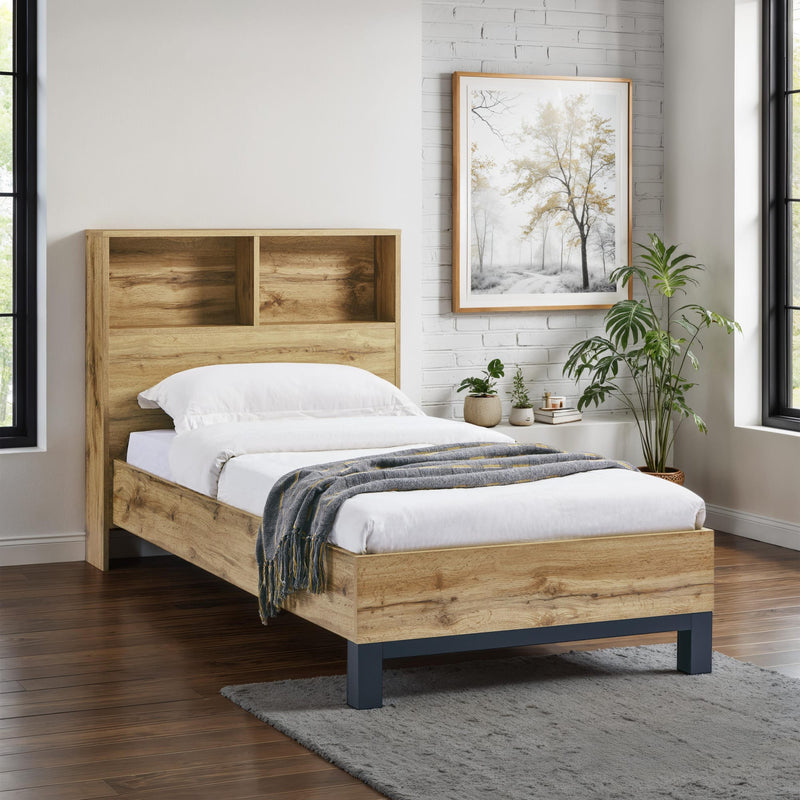 Wooden bed with white bedding and a plant in a room with large windows.