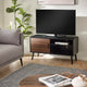 Modern living room with a TV on a wooden stand, gray sofa, and decorative items.