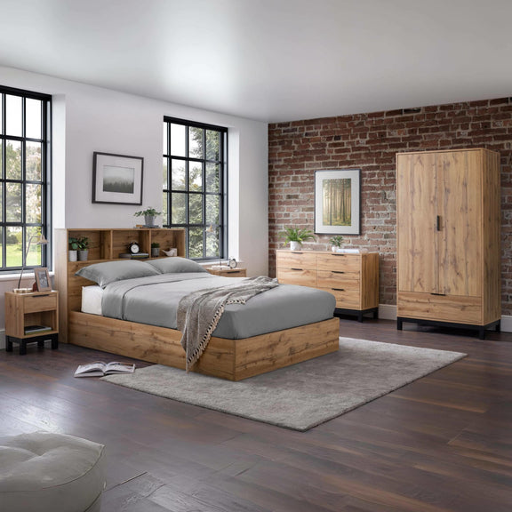 Wooden bedroom furniture set with bed, wardrobes, and nightstands in a room with brick wall.