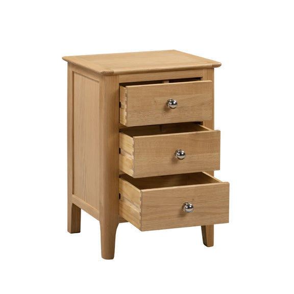 Wooden nightstand with three drawers on a white background