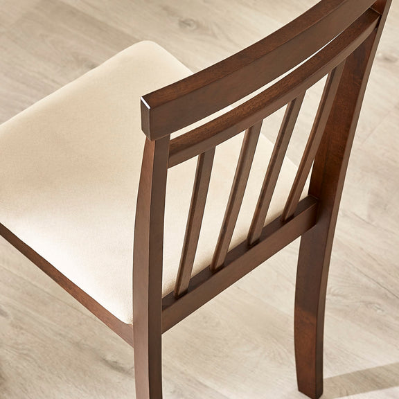Wooden chair with a cushioned seat on a light wooden floor