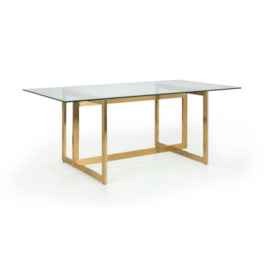 Modern dining table with glass top and gold metal frame on a white background