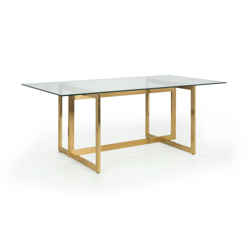 Modern dining table with glass top and gold metal frame on a white background