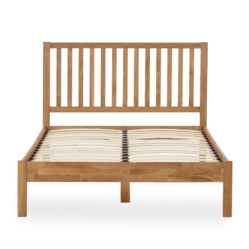 Wooden bed frame with slatted headboard on a white background