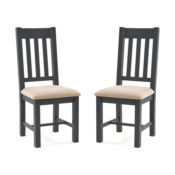 Two black chairs with beige cushions on a white background