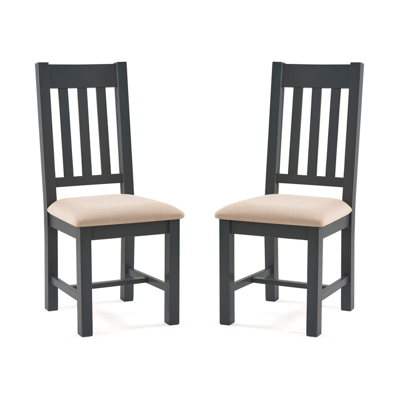 Two black chairs with beige cushions on a white background