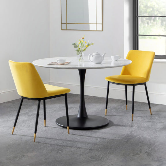 Dining table with two yellow chairs in a modern room.