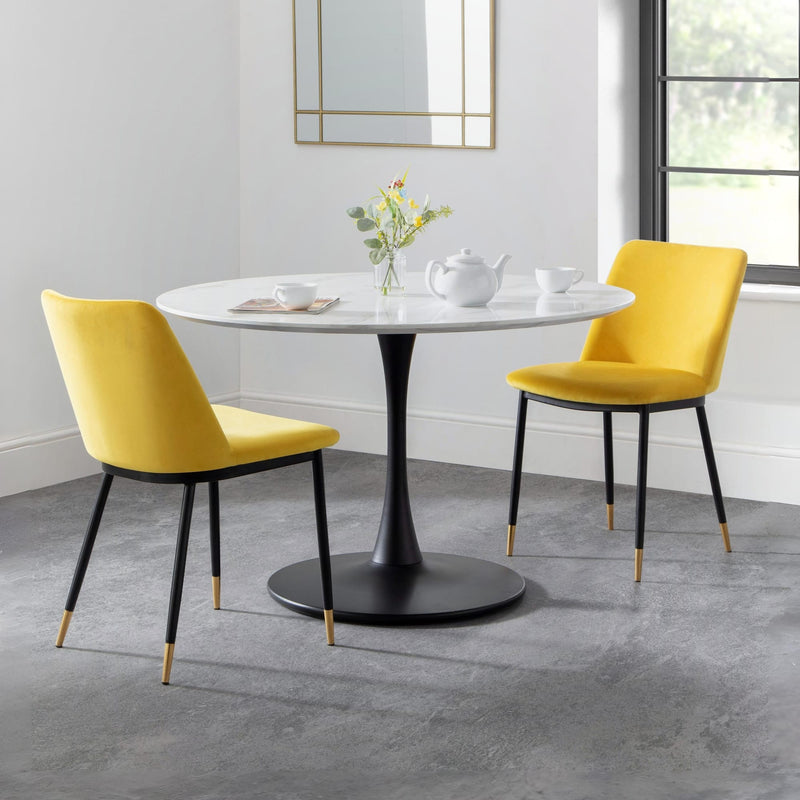 Dining table with two yellow chairs in a modern room.