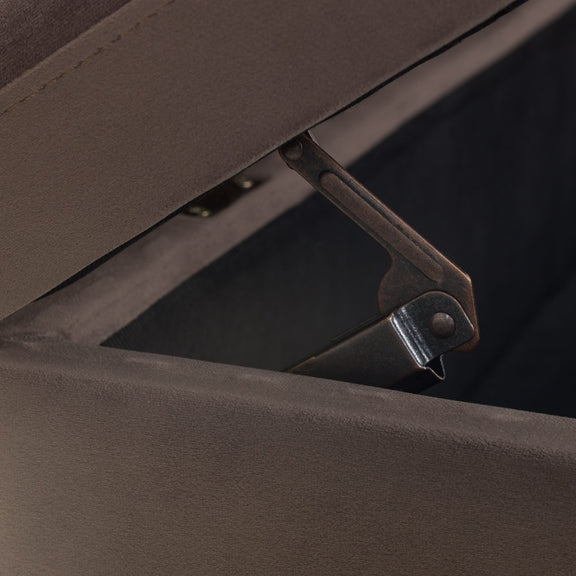 Close-up of a brown upholstered chair with a visible hinge.