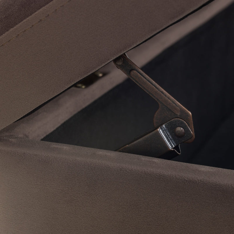 Close-up of a brown upholstered chair with a visible hinge.