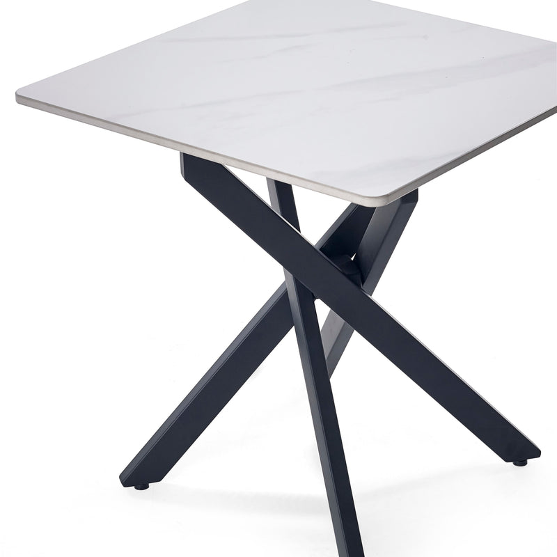 Table with white top and black X-shaped legs on a white background