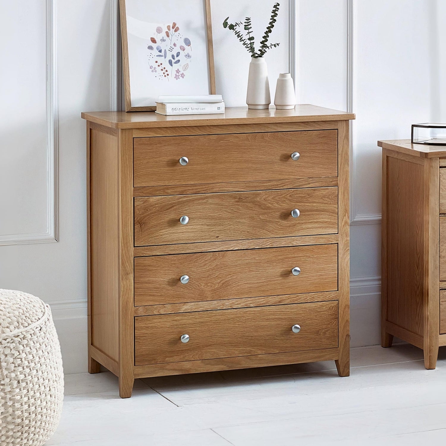 Wooden dresser with four drawers in a room setting.