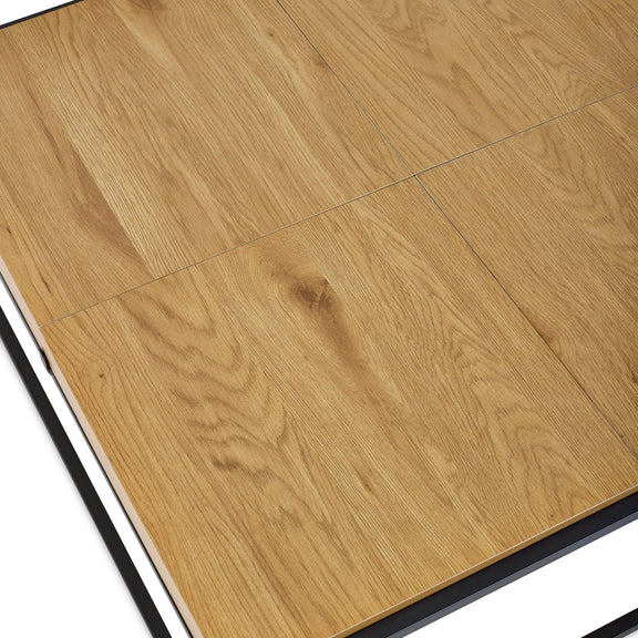 Close-up of wooden flooring tiles with a visible grain pattern.