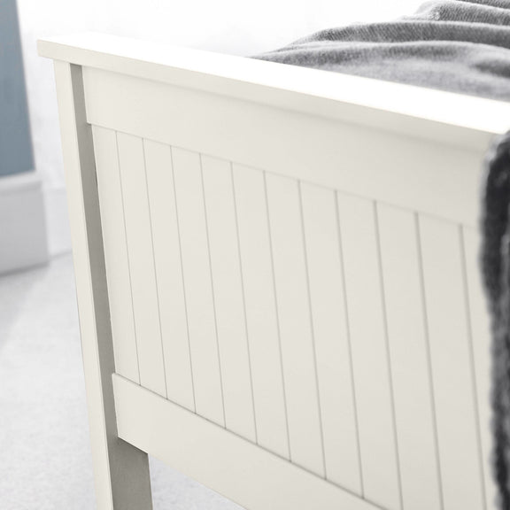 White wooden headboard with a blurred background