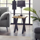 Modern living room with a side table, lamp, and gray sofa.