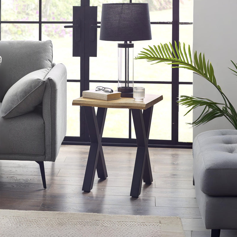 Modern living room with a side table, lamp, and gray sofa.