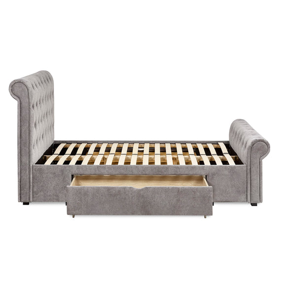 Gray upholstered bed with a wooden slatted frame and drawer on a white background