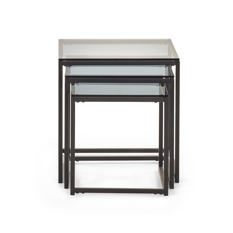 Set of three nesting tables with glass tops on a white background