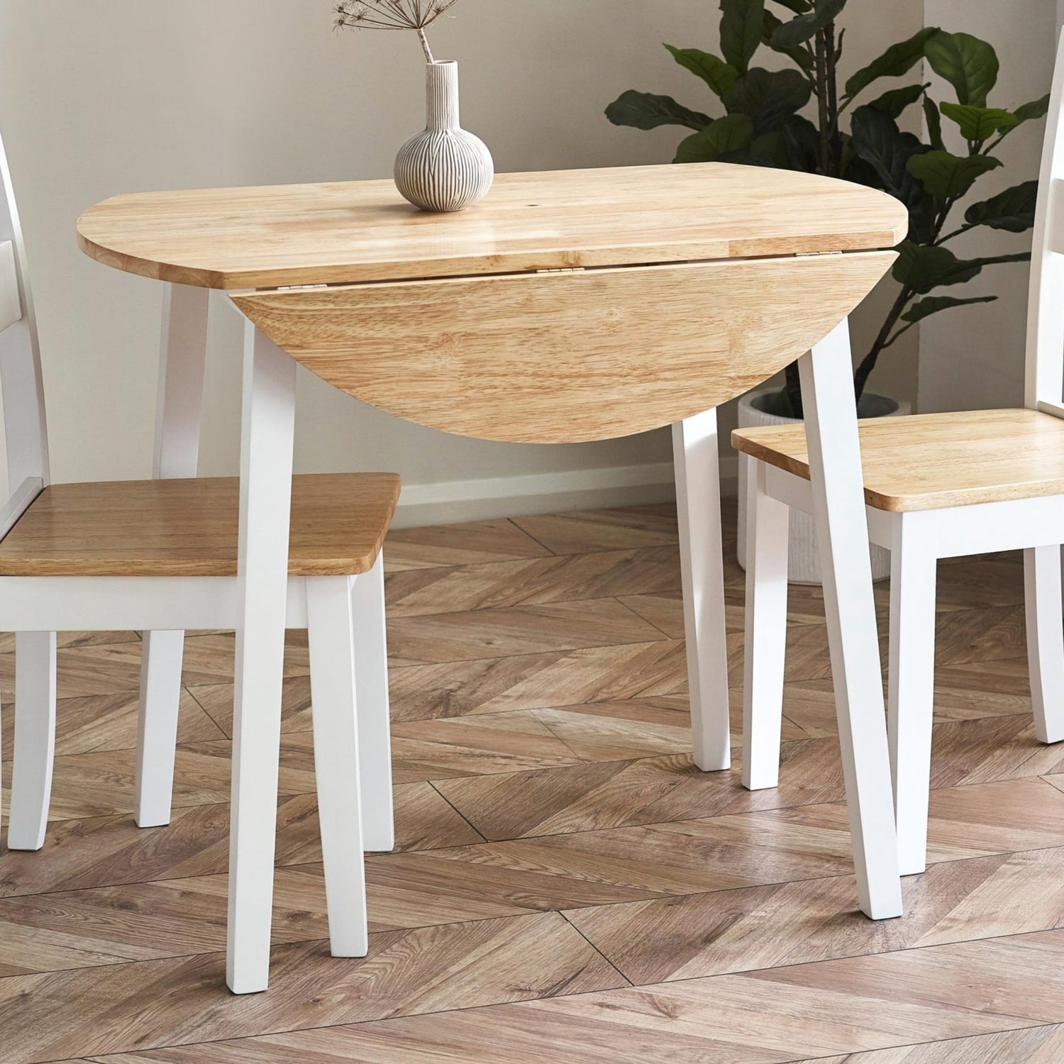 Wooden dining table with chairs on a wooden floor