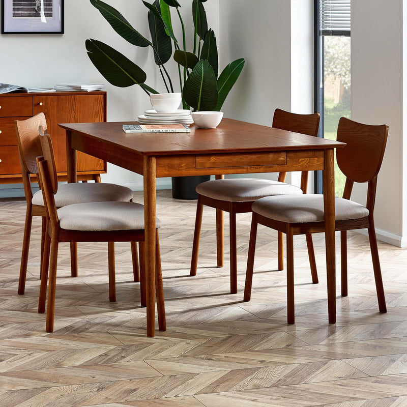 Dining room with wooden table and chairs on a herringbone floor