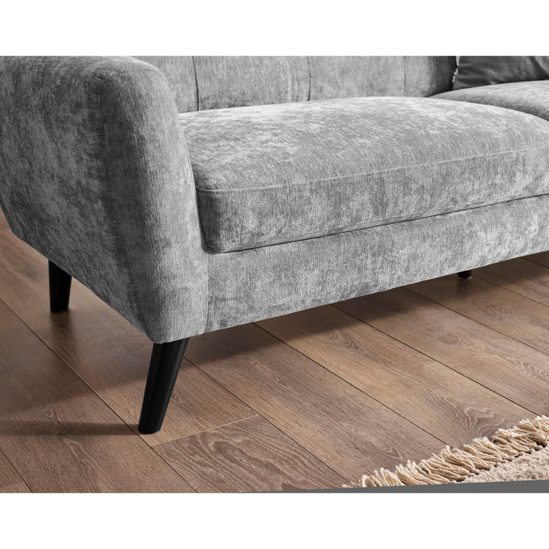 Gray sofa on a wooden floor with a rug partially visible