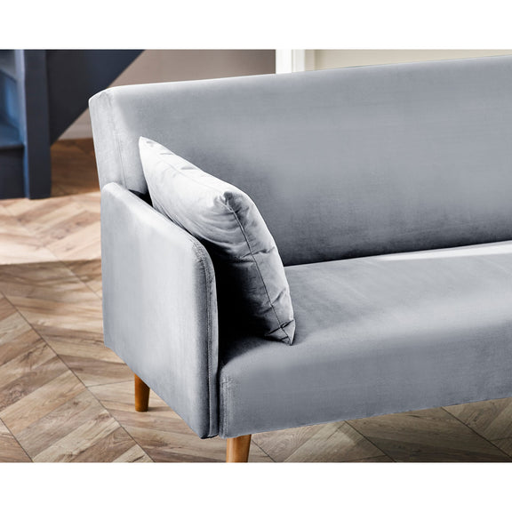 Gray sofa with wooden legs on a wooden floor