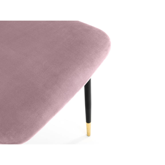 Pink velvet chair with black and gold legs on a white background