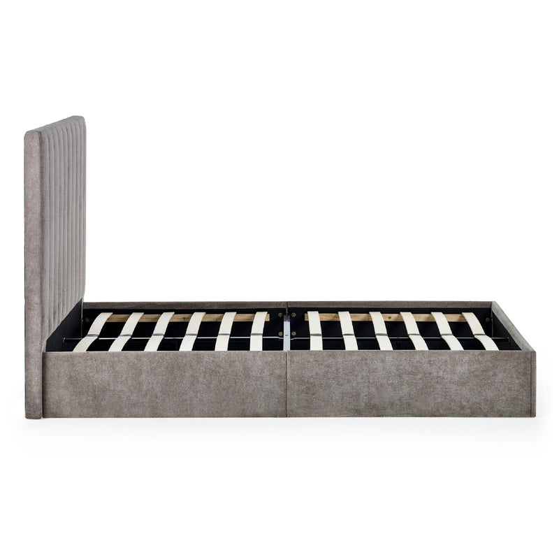Gray upholstered bed frame with striped mattress on a white background