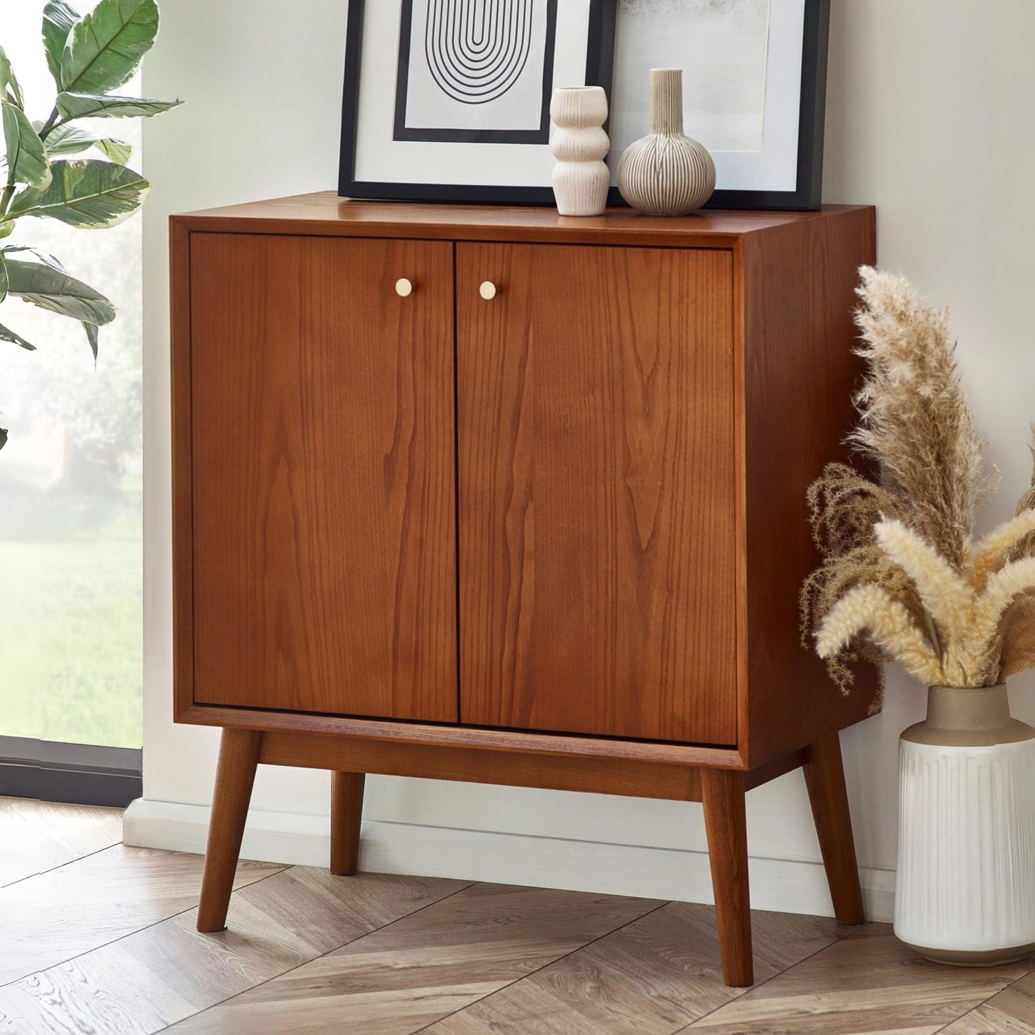 Wooden cabinet with two doors in a room with decor elements.