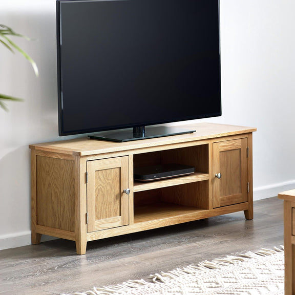 Wooden TV stand with a television mounted on it in a room.