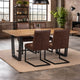 Dining area with wooden table and brown leather chairs in a modern interior setting.