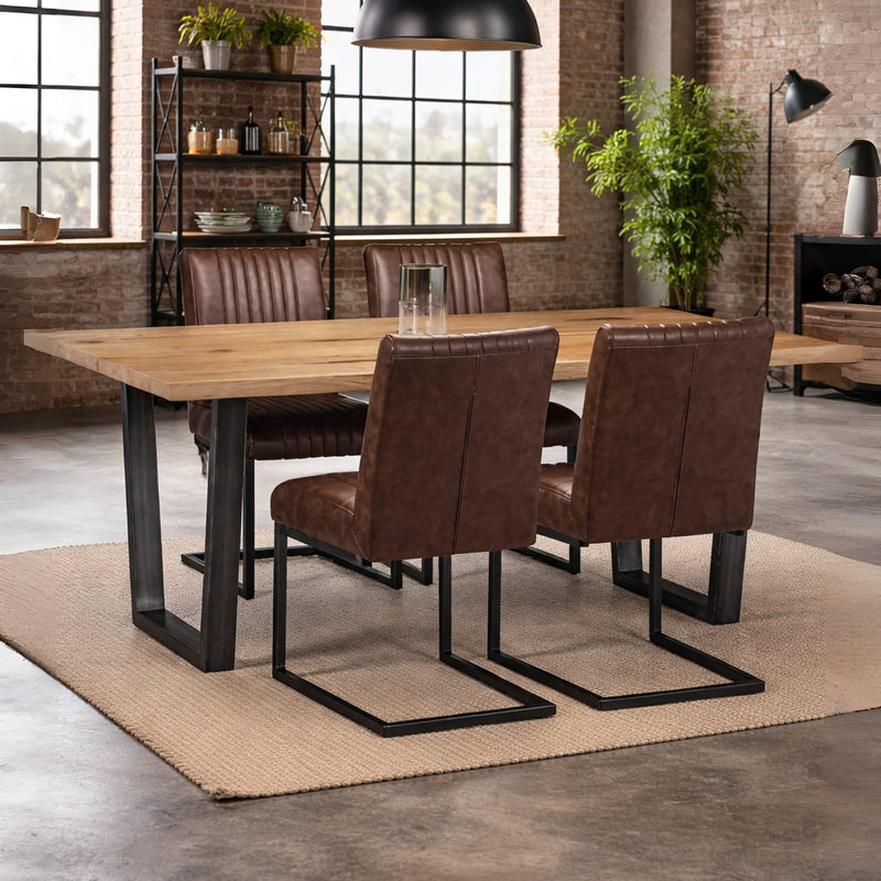 Dining area with wooden table and brown leather chairs in a modern interior setting.