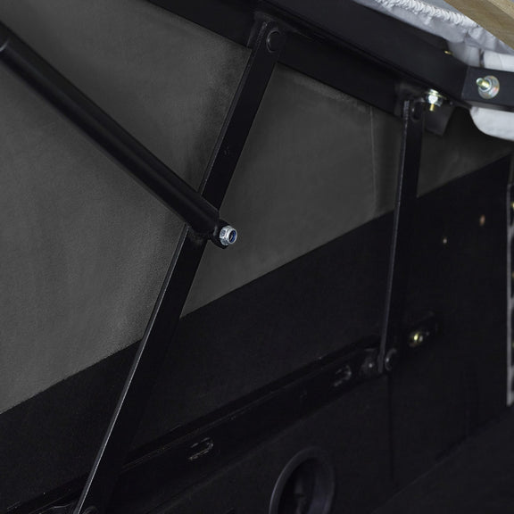 Close-up of a black metal bracket on a vehicle's interior door panel.