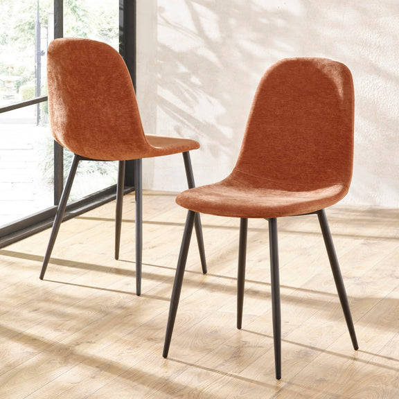 Two brown chairs with black legs on a light wooden floor.