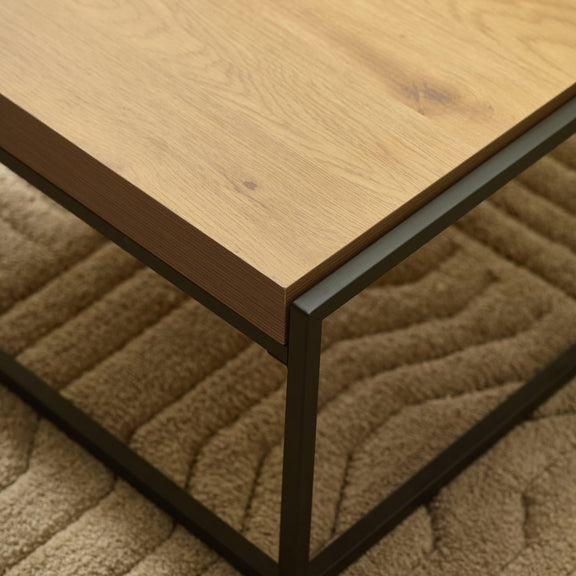 Wooden table with black metal legs on a textured surface