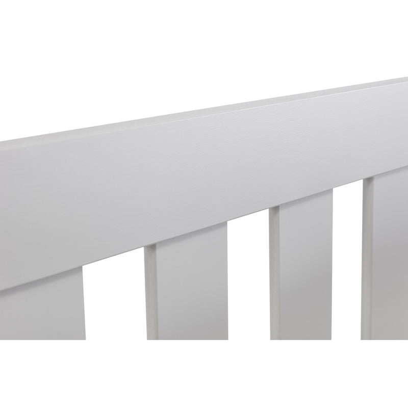 Close-up of a white crib with slatted design on a white background