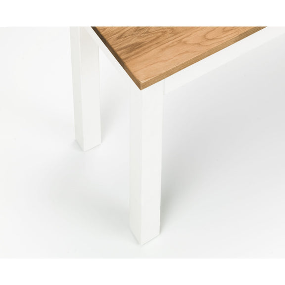 White paper with a wooden surface partially visible at the top.