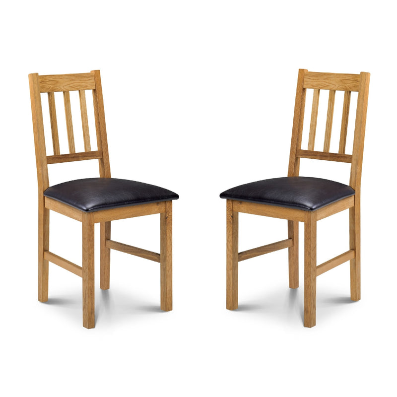 Two wooden chairs with black cushioned seats on a white background