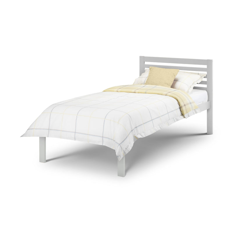 White bed frame with white bedding and a yellow blanket on a white background