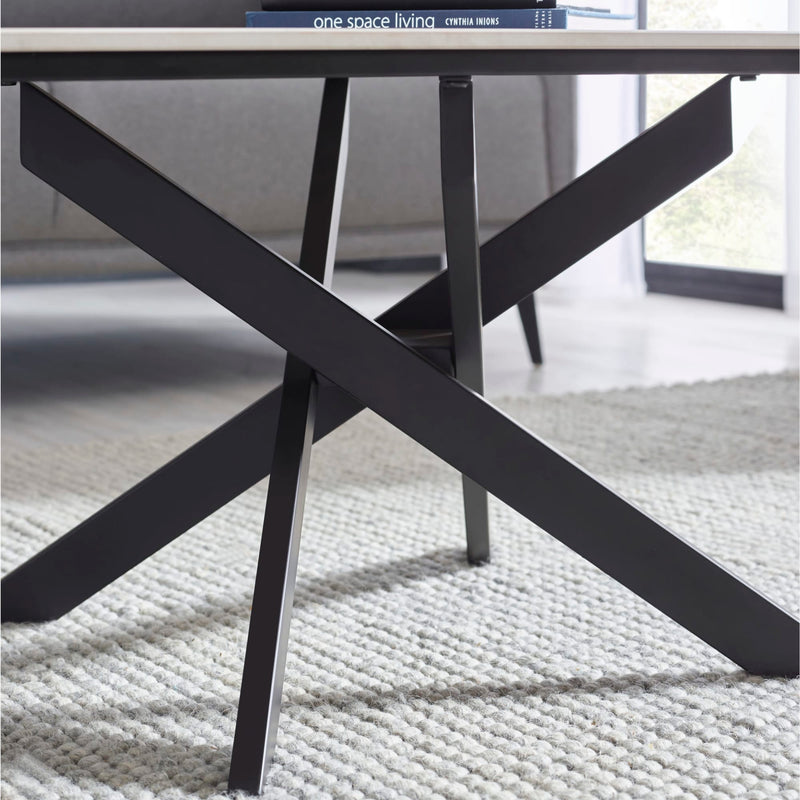 Black metal table with X-shaped legs on a textured surface, with 'one space living' branding visible.