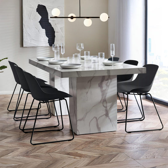 Modern dining room with marble table and black chairs