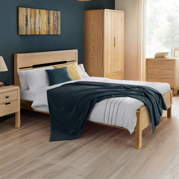 Wooden bedroom furniture set with bed, wardrobe, and nightstands.